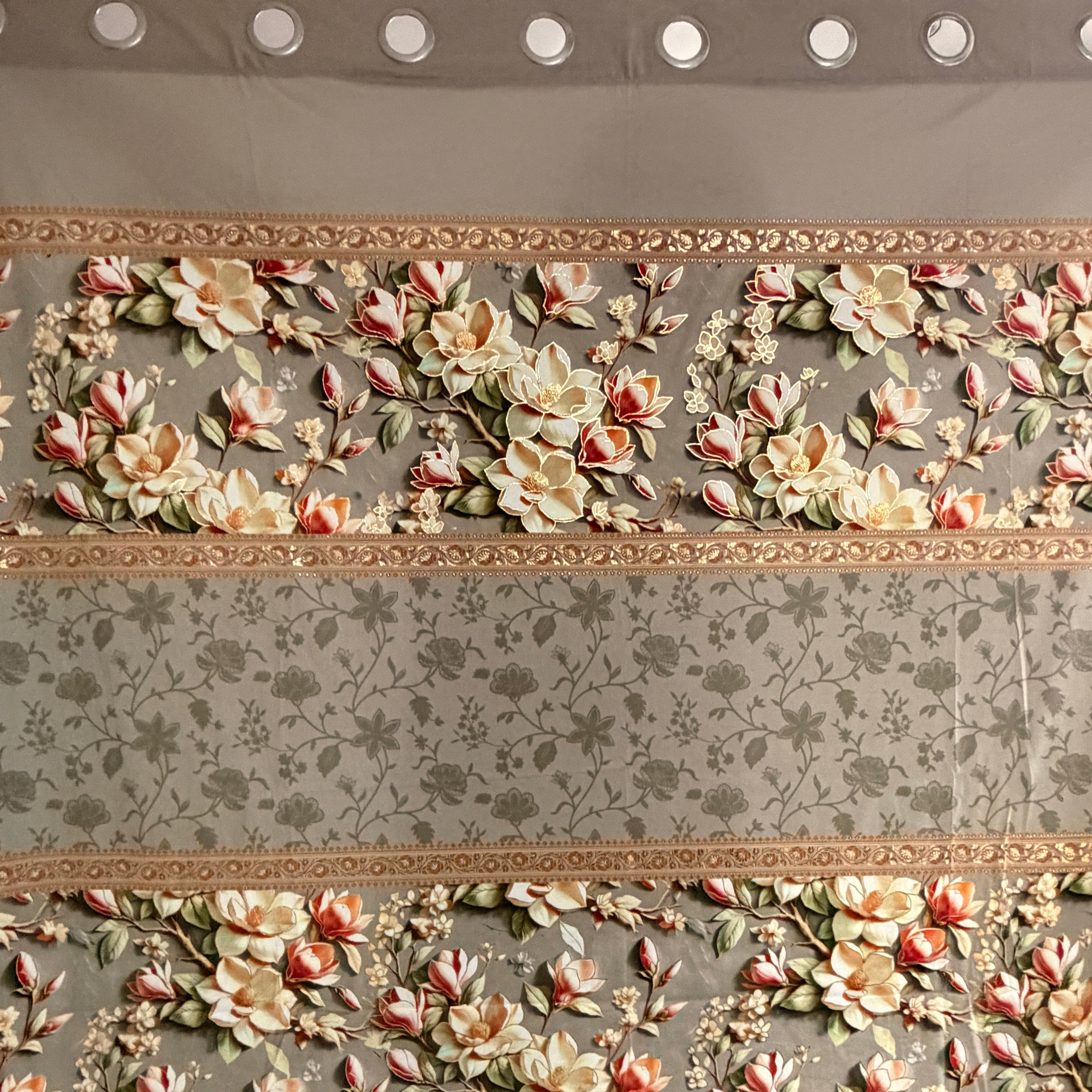 Floral patterned curtain with decorative border on a plain background