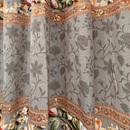 Decorative fabric with floral and paisley patterns on a gray background