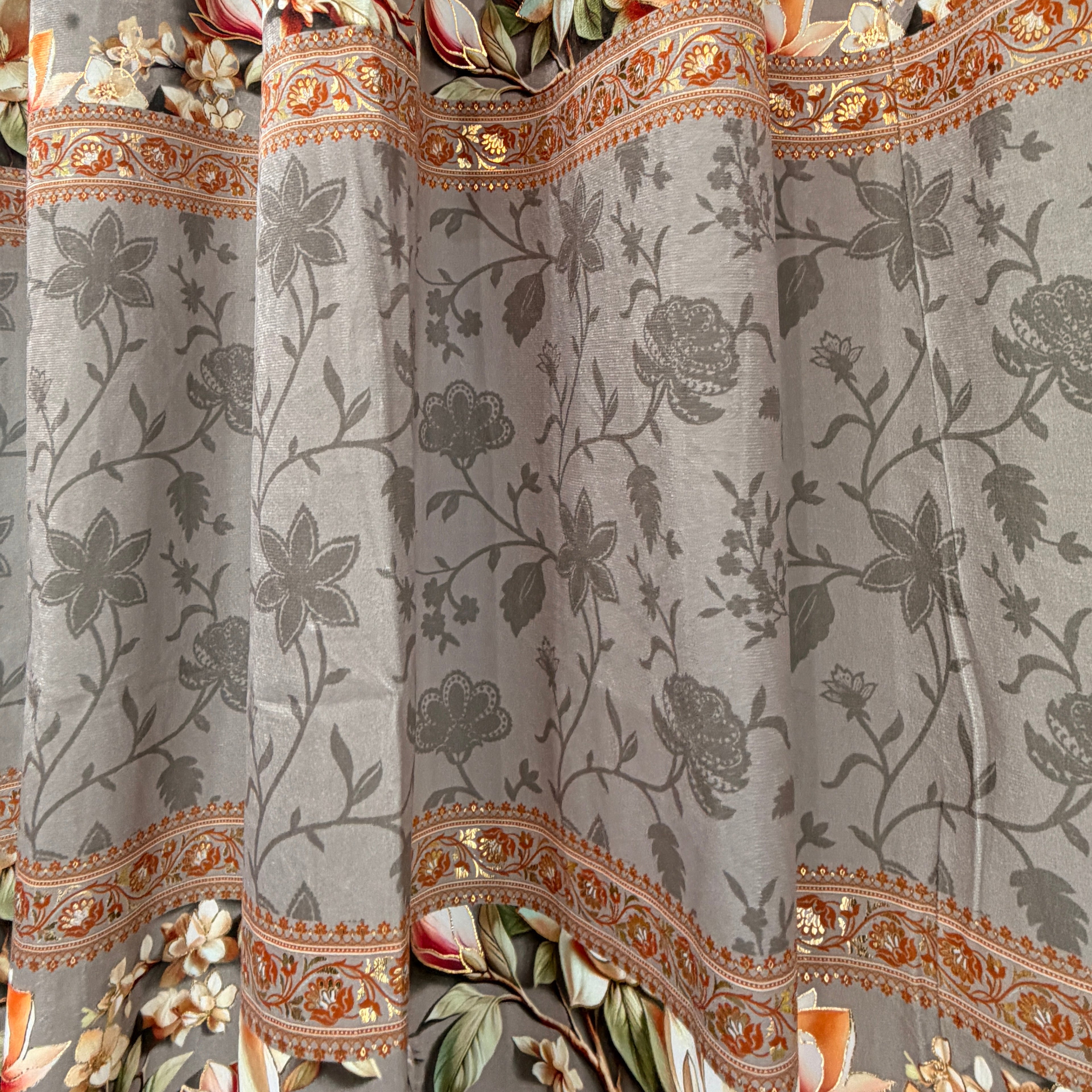Decorative fabric with floral and paisley patterns on a gray background